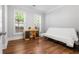 Bedroom with natural light showcases hardwood floors, a desk, and futon to comfortably fit guests at 2548 Crescent Park Ct # 7, Atlanta, GA 30339