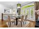 Elegant dining room with glass table and upholstered chairs near arched windows and doors to the outside at 2548 Crescent Park Ct # 7, Atlanta, GA 30339