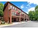 Brick townhomes feature private garages and balconies, beautifully lined with trees and foliage at 2548 Crescent Park Ct # 7, Atlanta, GA 30339