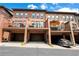 Stunning brick townhomes with private garages and balconies, enhanced by lush greenery at 2548 Crescent Park Ct # 7, Atlanta, GA 30339
