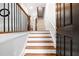 Elegant foyer featuring hardwood stairs, decorative railings, and bright, neutral paint at 2548 Crescent Park Ct # 7, Atlanta, GA 30339