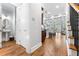 Inviting hallway featuring hardwood floors, a powder room, and views of an open-concept kitchen and living area at 2548 Crescent Park Ct # 7, Atlanta, GA 30339
