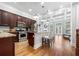 Open kitchen featuring dark wood cabinetry, granite countertops, stainless steel appliances, and an island with seating at 2548 Crescent Park Ct # 7, Atlanta, GA 30339