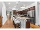 Gourmet kitchen with dark wood cabinets, granite counters, stainless steel appliances, and island with barstool seating at 2548 Crescent Park Ct # 7, Atlanta, GA 30339