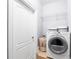 Bright laundry room features a front loading washer, wire rack shelving, and a charming laundry basket at 2548 Crescent Park Ct # 7, Atlanta, GA 30339