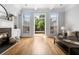 Living room with hardwood floors, fireplace, and large windows providing natural light and views of the backyard at 2548 Crescent Park Ct # 7, Atlanta, GA 30339