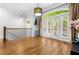 Bright living space with hardwood flooring, access to a balcony, and stylish light fixtures at 2548 Crescent Park Ct # 7, Atlanta, GA 30339