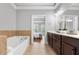 Main bathroom featuring double vanity, soaking tub and view to the main bedroom at 2548 Crescent Park Ct # 7, Atlanta, GA 30339