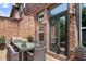 Cozy outdoor patio with dining furniture, surrounded by a brick facade and lush greenery at 2548 Crescent Park Ct # 7, Atlanta, GA 30339