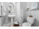 Cozy powder room features a pedestal sink, oval mirror, stylish decor, and a nearby toilet at 2548 Crescent Park Ct # 7, Atlanta, GA 30339