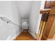 Carpeted staircase with wooden railing and white walls lead to the upper level of the home at 2548 Crescent Park Ct # 7, Atlanta, GA 30339