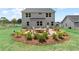 Spacious backyard featuring a stone fire pit, comfortable seating, lush landscaping, and a well-maintained lawn at 410 Beacon Way Way, Villa Rica, GA 30180