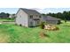Expansive backyard with a cozy fire pit, lush green lawn, and a young tree planted at 410 Beacon Way Way, Villa Rica, GA 30180