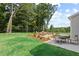 Outdoor patio with dining table and chairs, and outdoor lounge area with comfortable seating surrounding fire pit at 410 Beacon Way Way, Villa Rica, GA 30180