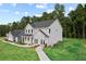 Lovely home showcasing gray siding, a lush green lawn, mature trees, and a connecting two-car garage at 410 Beacon Way Way, Villa Rica, GA 30180