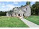 Beautiful house featuring gray siding, a lush green lawn, mature trees, and an attached two-car garage at 410 Beacon Way Way, Villa Rica, GA 30180