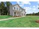 Attractive home featuring gray siding, a lush green lawn, mature trees, and an inviting front entrance at 410 Beacon Way Way, Villa Rica, GA 30180