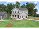Beautiful two-story home with a well-manicured lawn, classic gray siding, and a welcoming entrance at 410 Beacon Way Way, Villa Rica, GA 30180
