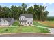 Beautifully landscaped home featuring classic gray siding, a lush green lawn, and mature trees at 410 Beacon Way Way, Villa Rica, GA 30180