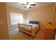 Comfortable bedroom with a wooden bed frame, patterned bedding, and a window at 8145 Lakeview Pkwy, Villa Rica, GA 30180