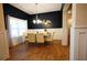 Elegant dining room with wainscoting, modern lighting, and ample seating at 8145 Lakeview Pkwy, Villa Rica, GA 30180
