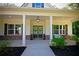 Inviting front porch with double doors, brick accents, and stylish outdoor seating at 8145 Lakeview Pkwy, Villa Rica, GA 30180