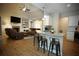 Open-concept living area with a fireplace, television, and kitchen island with granite countertops at 8145 Lakeview Pkwy, Villa Rica, GA 30180