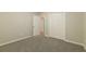 Bedroom featuring a double-door closet and neutral carpet at 8607 Wood Springs Ct, Douglasville, GA 30135
