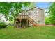 Back exterior with a wooden deck and yard surrounded by trees at 8607 Wood Springs Ct, Douglasville, GA 30135