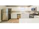 Modern kitchen with stainless steel appliances, white cabinets, and quartz countertops at 8607 Wood Springs Ct, Douglasville, GA 30135