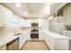Bright kitchen with stainless steel appliances, light-colored cabinets, and countertop space at 8607 Wood Springs Ct, Douglasville, GA 30135