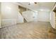 Open-concept living space with tile flooring, staircase, and natural light at 8607 Wood Springs Ct, Douglasville, GA 30135