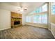 Bright living room featuring a stone fireplace, hardwood floors, and large windows at 8607 Wood Springs Ct, Douglasville, GA 30135