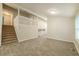 Spacious living area with tile floors, staircase, and ample natural light at 8607 Wood Springs Ct, Douglasville, GA 30135