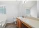 Bright bathroom featuring wood-look flooring, a tub and shower combination and a large mirror over the vanity at 503 Fable Ln, Canton, GA 30114
