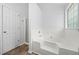 Relaxing bathroom with a soaking tub and separate glass-enclosed shower at 503 Fable Ln, Canton, GA 30114