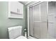 Bathroom featuring a shower, toilet, and a wall cabinet for storage at 503 Fable Ln, Canton, GA 30114