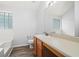 Neutral bathroom featuring wood-look floors, tiled walls, glass block window, and modern vanity at 503 Fable Ln, Canton, GA 30114
