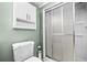 Bathroom featuring tiled shower stall, toilet, and cabinet for extra storage at 503 Fable Ln, Canton, GA 30114