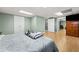 Bedroom featuring a bed, a dresser with a TV, and an adjoining bathroom at 503 Fable Ln, Canton, GA 30114