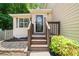Charming home featuring a quaint front entrance with a welcome sign and mature landscaping at 503 Fable Ln, Canton, GA 30114