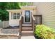 Charming covered front porch with a 'Welcome' sign on the front door and natural landscaping at 503 Fable Ln, Canton, GA 30114