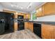 Bright kitchen with black appliances, light wood cabinets, and modern lighting at 503 Fable Ln, Canton, GA 30114