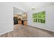 The kitchen features modern appliances, wooden cabinets, and large window at 503 Fable Ln, Canton, GA 30114