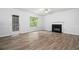 Open living room featuring a fireplace and natural light from the large window at 503 Fable Ln, Canton, GA 30114