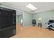 Living room with wood floors, two rolling office chairs, and stainless steel refrigerator at 503 Fable Ln, Canton, GA 30114