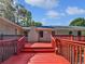Expansive back deck with red paint and white lattice surround and view of backyard and home at 5142 Golfbrook Ct, Stone Mountain, GA 30088