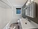 Bright bathroom with a tub, shower, single sink vanity and modern fixtures at 5142 Golfbrook Ct, Stone Mountain, GA 30088