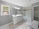 Bathroom featuring double sink vanity, shower-tub combo, and tile flooring at 5142 Golfbrook Ct, Stone Mountain, GA 30088