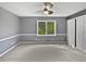 This bedroom offers natural light from a window and a ceiling fan for added comfort at 5142 Golfbrook Ct, Stone Mountain, GA 30088